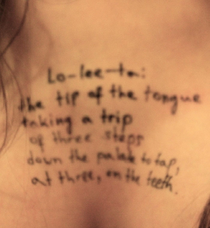 Close-up of a woman&rsquo;s chest showing handwritten disturbing messages from new Epstein files photos.