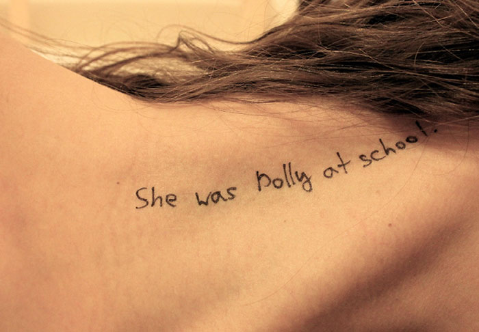 Close-up of a woman's shoulder with disturbing handwritten messages, related to new Epstein files photos.