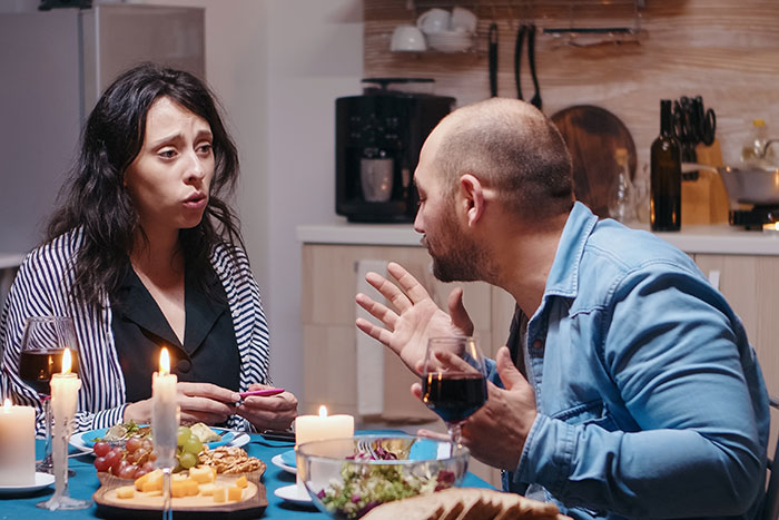 Couple having tense conversation at dinner, highlighting his girlfriend wanting him to close her closet door. Couple having tense conversation at dinner, highlighting his girlfriend wanting him to close her closet door.