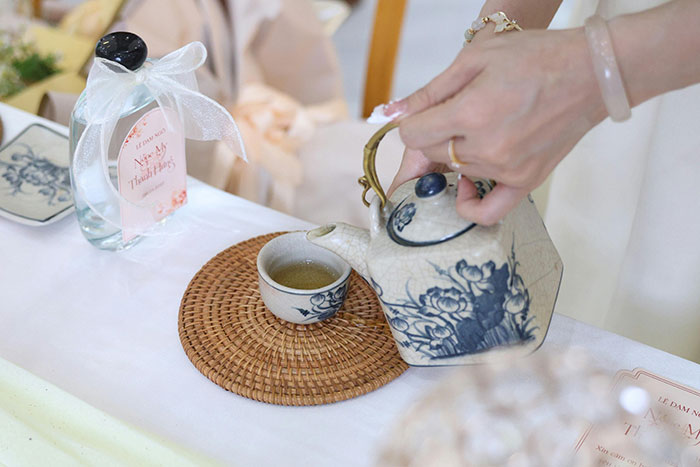 Man considers canceling wedding as fiancée’s family hires a private investigator to find dirt, tea ceremony setting with hands pouring tea. Man considers canceling wedding as fiancée’s family hires a private investigator to find dirt, tea ceremony setting with hands pouring tea.
