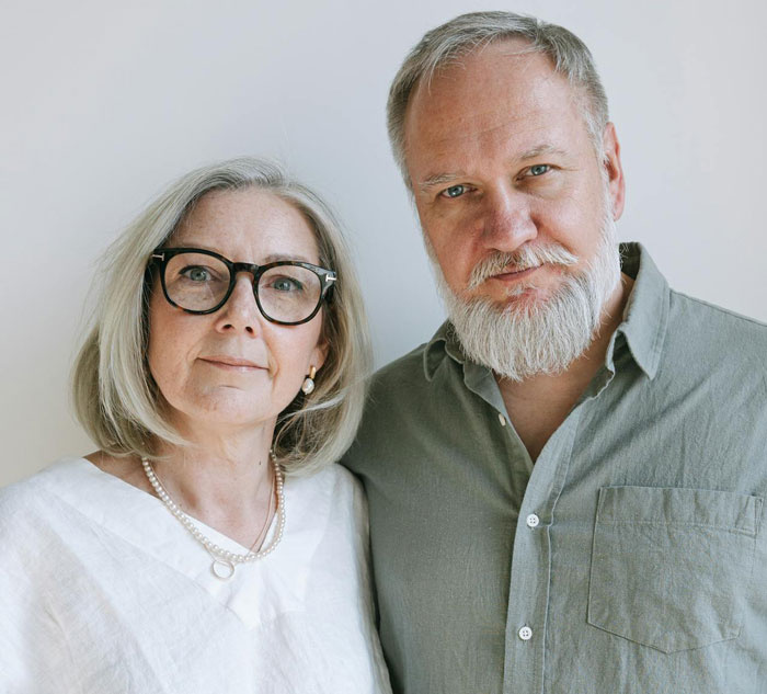 Middle-aged parents with serious expressions, representing the theme of man cutting off parents after revenge for small wedding planning.