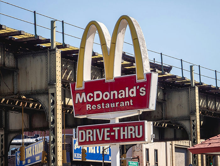 Old McDonald&rsquo;s restaurant drive-thru sign under elevated railway, related to final destination stuff accident news.