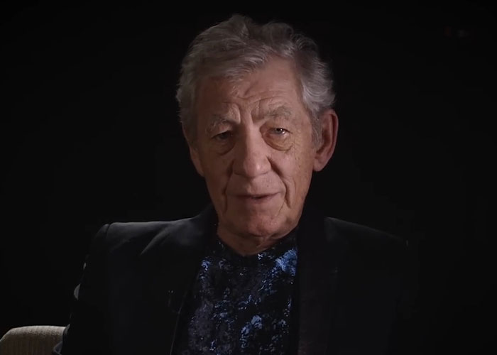 Elderly man sharing stories about famous people they have met in a dark setting for a viral interview series.