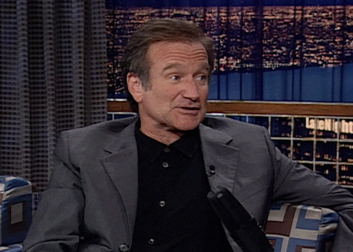 Actor on a late night talk show set sharing stories about famous people they've met and what they were like.