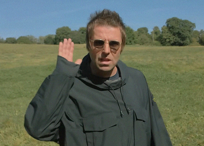 Man in sunglasses and dark jacket standing outdoors, sharing stories about famous people they've met.