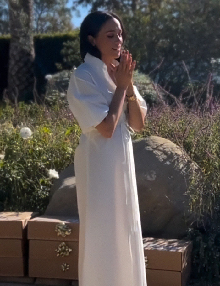 Meghan Markle in a white dress outdoors, appearing thoughtful, with rumors of Prince Harry split sparked by Christmas message Meghan Markle in a white dress outdoors, appearing thoughtful, with rumors of Prince Harry split sparked by Christmas message