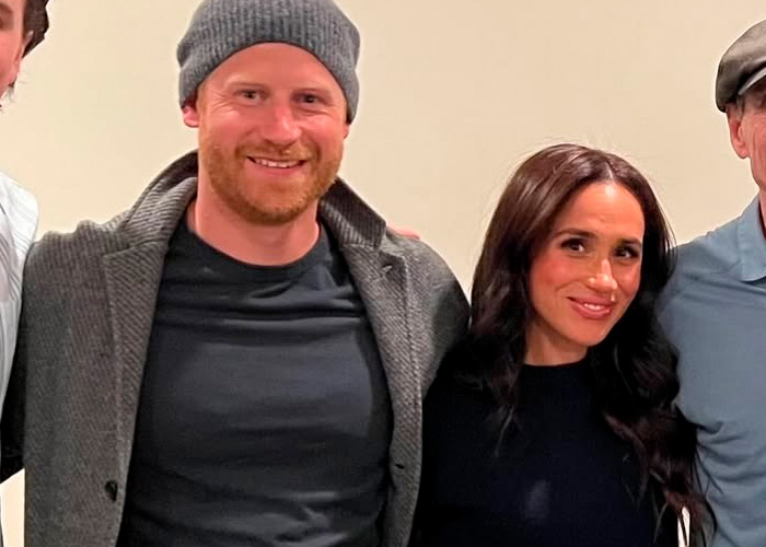 Prince Harry and Meghan Markle smiling together indoors with casual clothing and neutral background. Prince Harry and Meghan Markle smiling together indoors with casual clothing and neutral background.