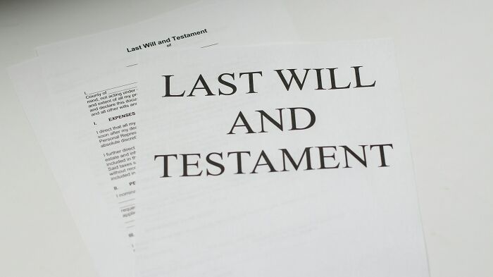 Last will and testament documents on a white surface related to funerals not going as expected scenarios.