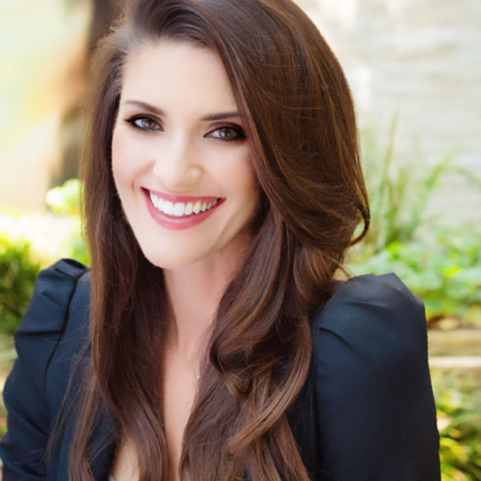 A smiling PR guru with long brown hair and a black top, discussing why they cut ties with Prince Harry and Meghan Markle. A smiling PR guru with long brown hair and a black top, discussing why they cut ties with Prince Harry and Meghan Markle.