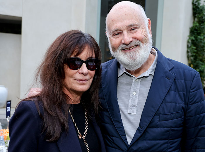 Rob Reiner smiling outdoors with a woman wearing sunglasses at a social event, headline about son confession. Rob Reiner smiling outdoors with a woman wearing sunglasses at a social event, headline about son confession.
