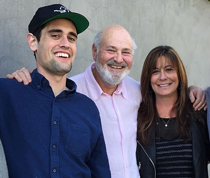 Rob Reiner smiling with two people at a casual gathering, related to disturbing last words and confession about son. Rob Reiner smiling with two people at a casual gathering, related to disturbing last words and confession about son.