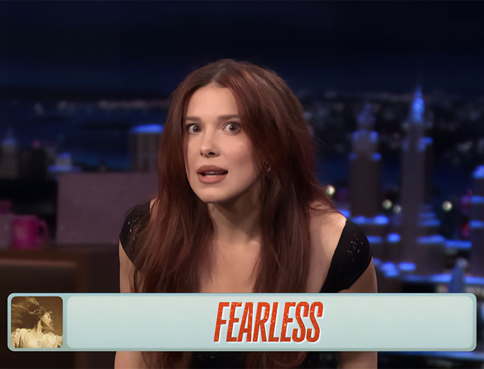 Woman with long red hair wearing a black top on a late night talk show set discussing Girl Skipped 20s appearance. Woman with long red hair wearing a black top on a late night talk show set discussing Girl Skipped 20s appearance.