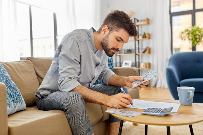 Man counting money and writing notes at a table, illustrating themes of cruel parents and refusal to help. Man counting money and writing notes at a table, illustrating themes of cruel parents and refusal to help.