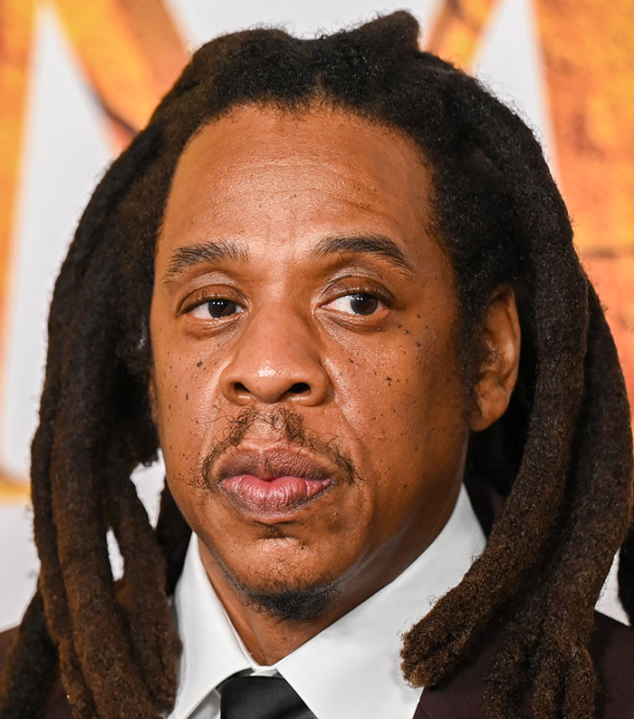 Close-up of a male celebrity with dreadlocks at an event representing the most disliked celebrities of 2025.