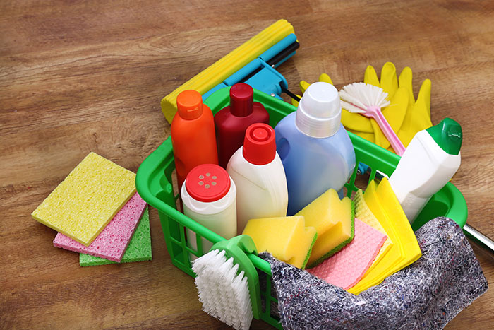 Cleaning supplies assortment in a green basket symbolizing common causes of wrong self-diagnoses by doctors.
