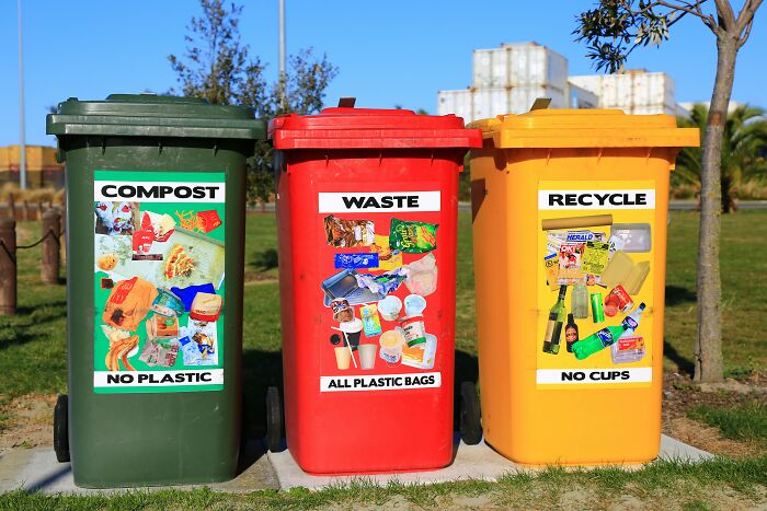 Three outdoor bins labeled compost, waste, and recycle highlight hidden industry truths about waste management and recycling.