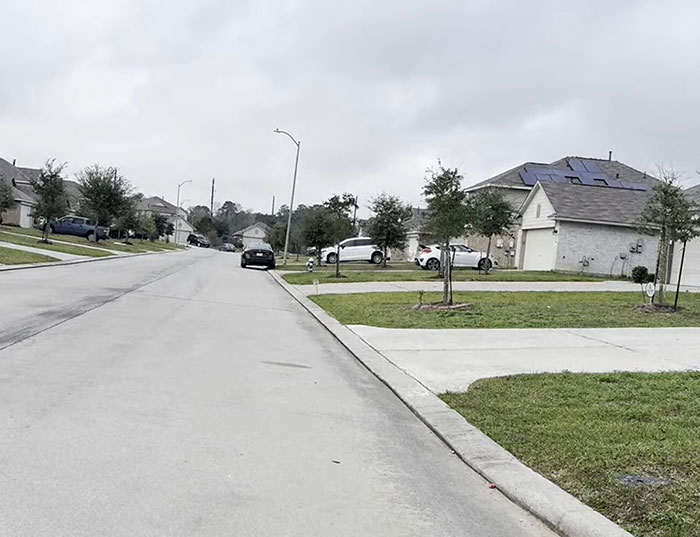 Suburban Texas neighborhood street with houses and cars, related to heroic Texas dad rescuing kidnapped daughter. Suburban Texas neighborhood street with houses and cars, related to heroic Texas dad rescuing kidnapped daughter.