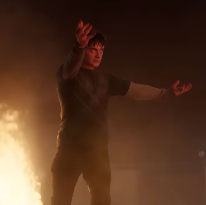 Noah Schnapp scene recreation from Stranger Things season with dramatic pose amid acting backlash and fiery background.