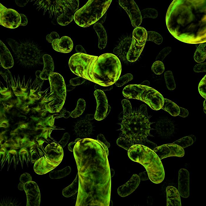 Close-up view of green bacteria and viruses under a microscope illustrating facts that sound made up but are actually true.