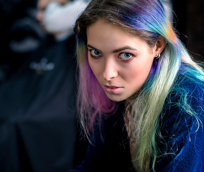 Teen with colorful hair and intense gaze, illustrating selfish and unloving sociopath behavior in troubled youth.