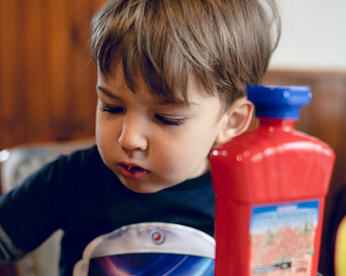 Young boy with serious expression sitting at table, illustrating moments parents realized their kids are sociopaths.