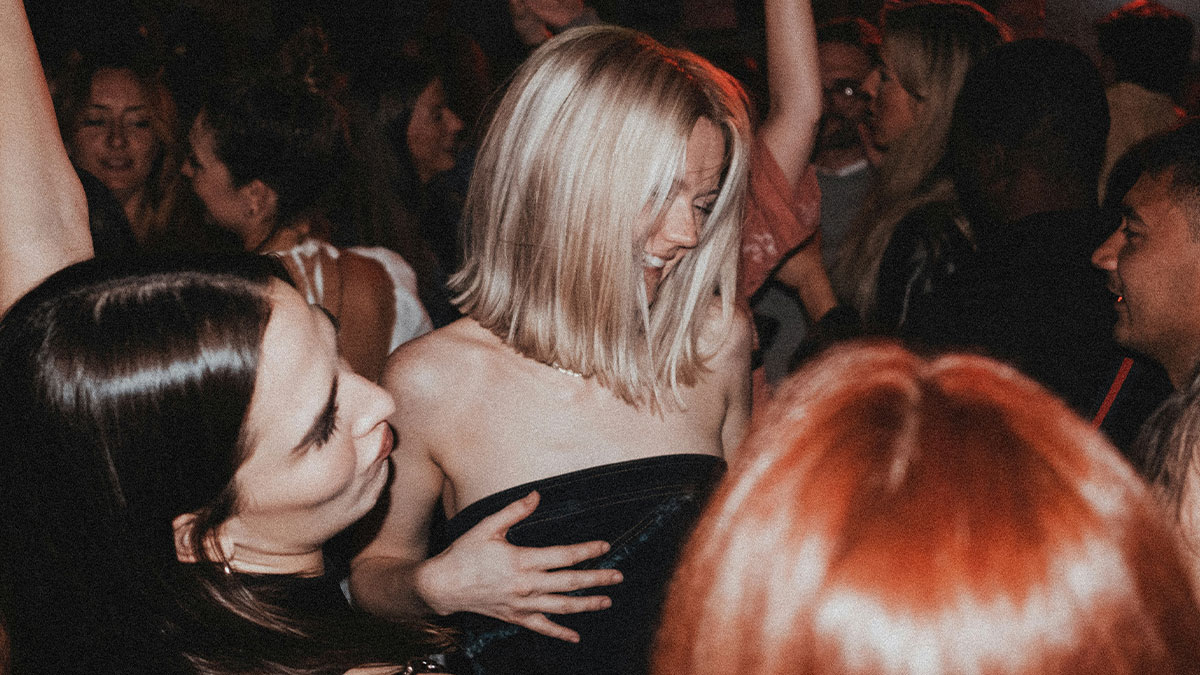 Crowd of people dancing and socializing at a party, capturing next-level evil kids with intense expressions.