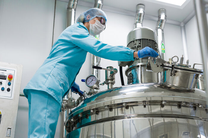 Worker in protective gear operating industrial machinery, representing people sharing the fastest they ever quit a job