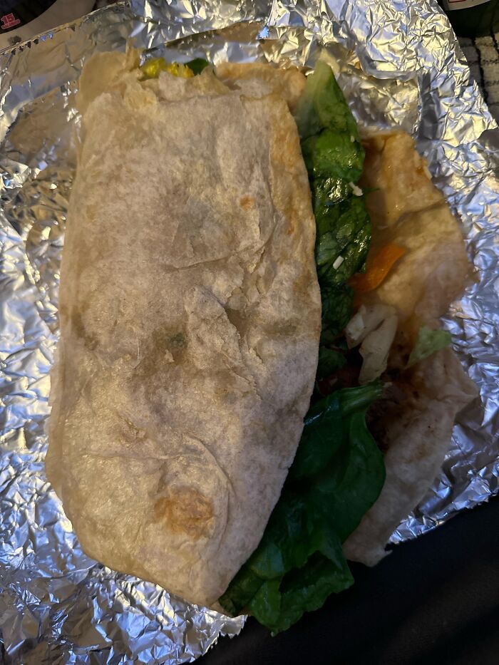 Partially unwrapped sandwich with leafy greens on foil, symbolizing people sharing the fastest they ever quit a job.