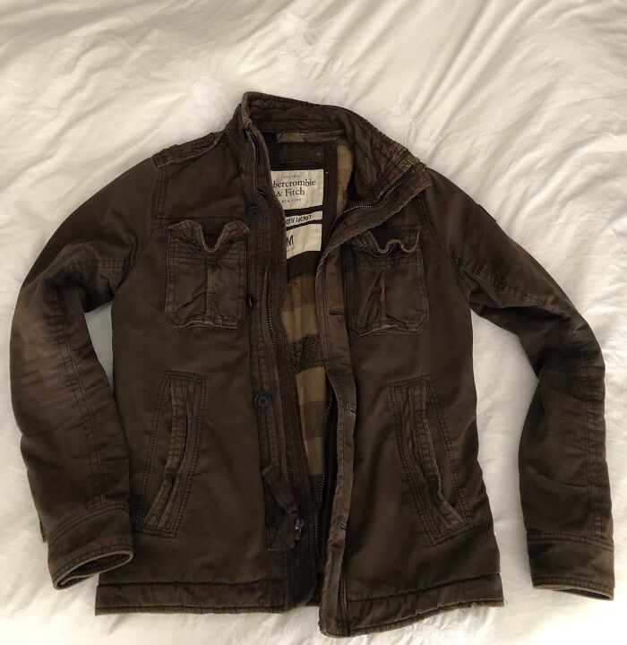 Brown Abercrombie & Fitch jacket laid out flat on a white bed, symbolizing people sharing the fastest they quit a job.
