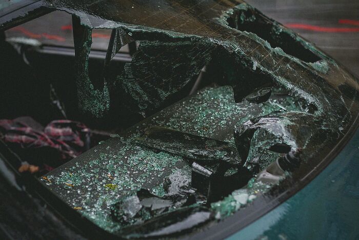 Broken car window with shattered glass inside, capturing a scary sight people still talk about as if it happened yesterday.