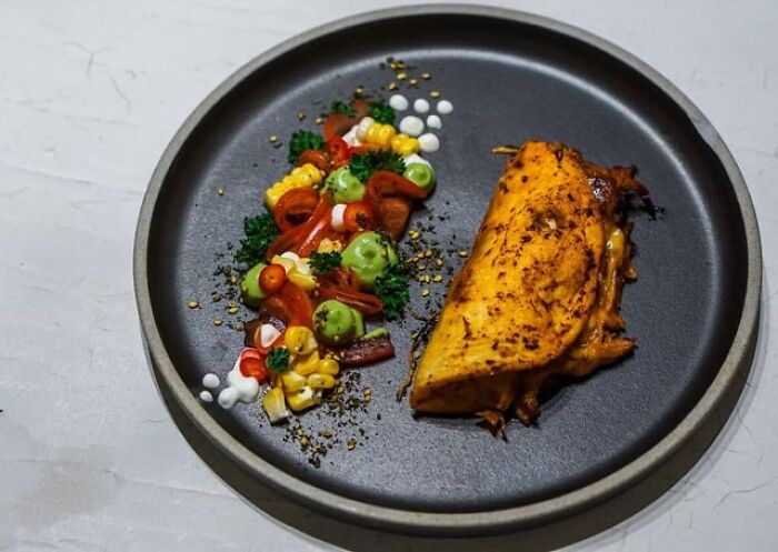 A delicious plate featuring a simple dish with grilled chicken and fresh vegetable garnish for foodies.