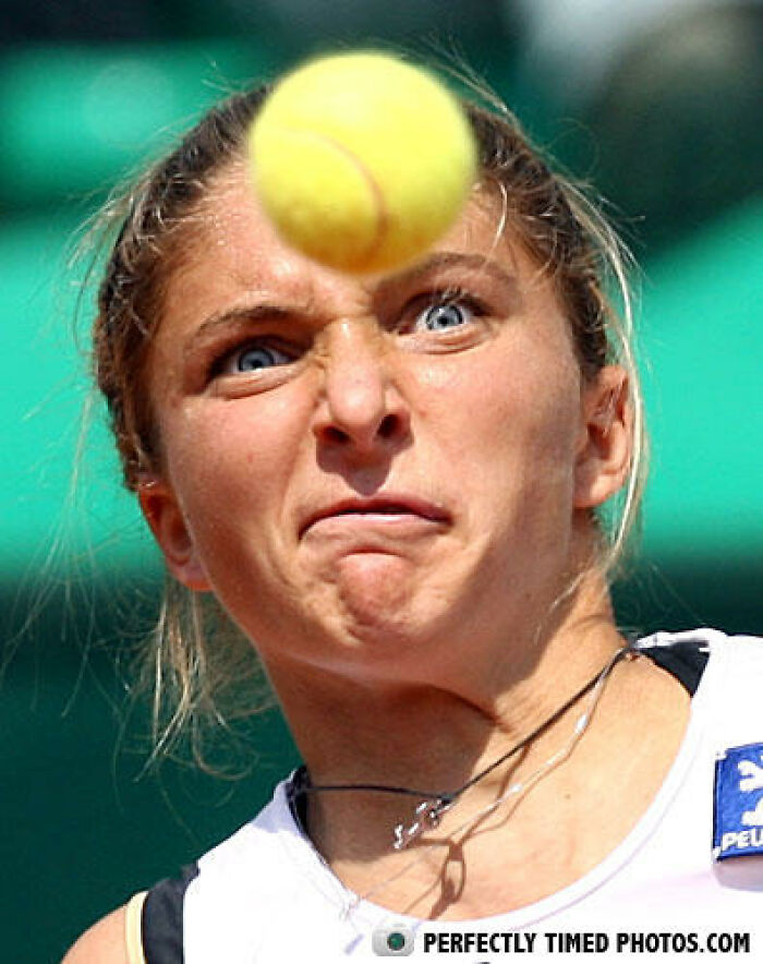 Tennis player with intense focus hitting a yellow ball, showcasing perfectly timed photos capturing incredible moments.
