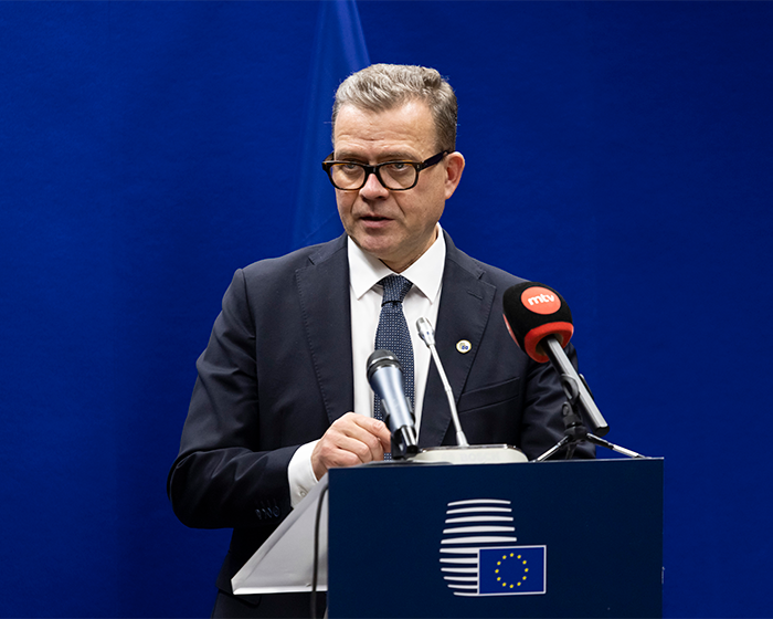 Japan government official speaking at a podium with microphones amid controversy over Finnish beauty queen's racist gesture. Japan government official speaking at a podium with microphones amid controversy over Finnish beauty queen's racist gesture.