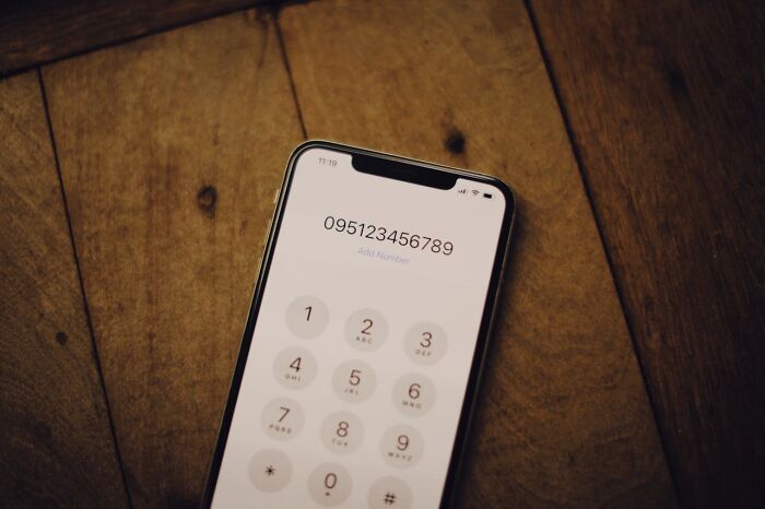 Smartphone showing dial pad and phone number, illustrating brilliantly sneaky acts of revenge ideas.