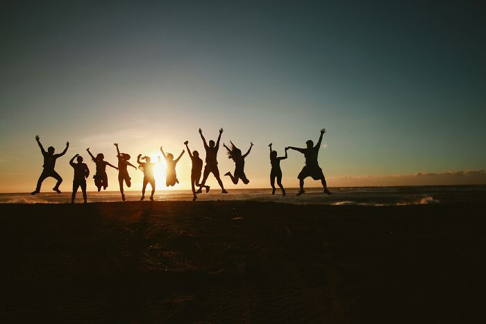 Group of people jumping at sunset on a beach, representing useless facts about Dolly Parton and the oldest tortoise. Group of people jumping at sunset on a beach, representing useless facts about Dolly Parton and the oldest tortoise.