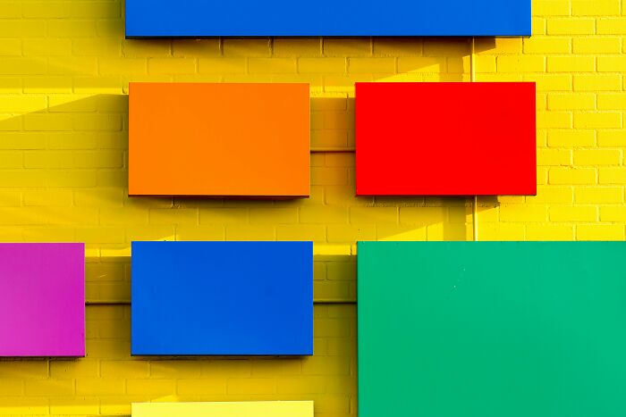 Colorful rectangular panels mounted on a bright yellow brick wall, highlighting creativity and sharp IQ test challenge. Colorful rectangular panels mounted on a bright yellow brick wall, highlighting creativity and sharp IQ test challenge.
