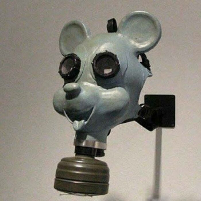 Surreal gas mask shaped like a cartoon mouse head, blending historical and iconic design elements.