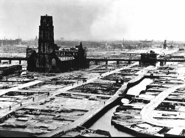 Black and white historical picture showing ruins surrounding an old church in a desolate urban landscape.
