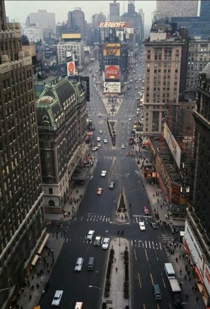 Vintage aerial view of a busy city street with classic buildings and historic signage in an iconic urban scene.