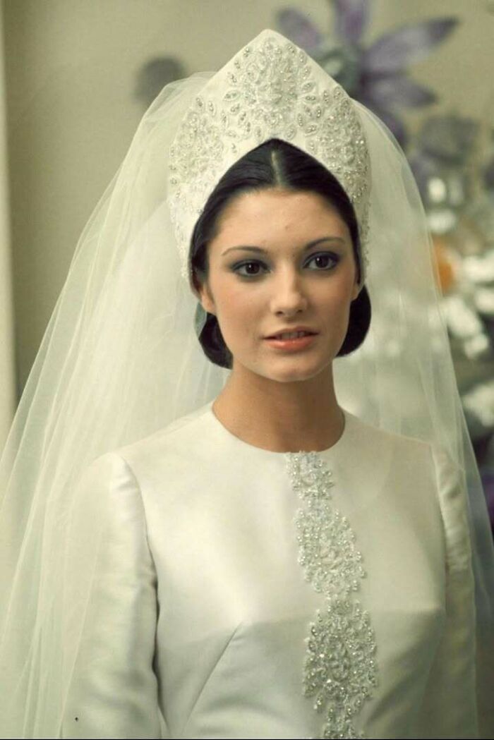 Portrait of a classic bride in an elegant vintage wedding dress and detailed headpiece, a beautiful historical picture.