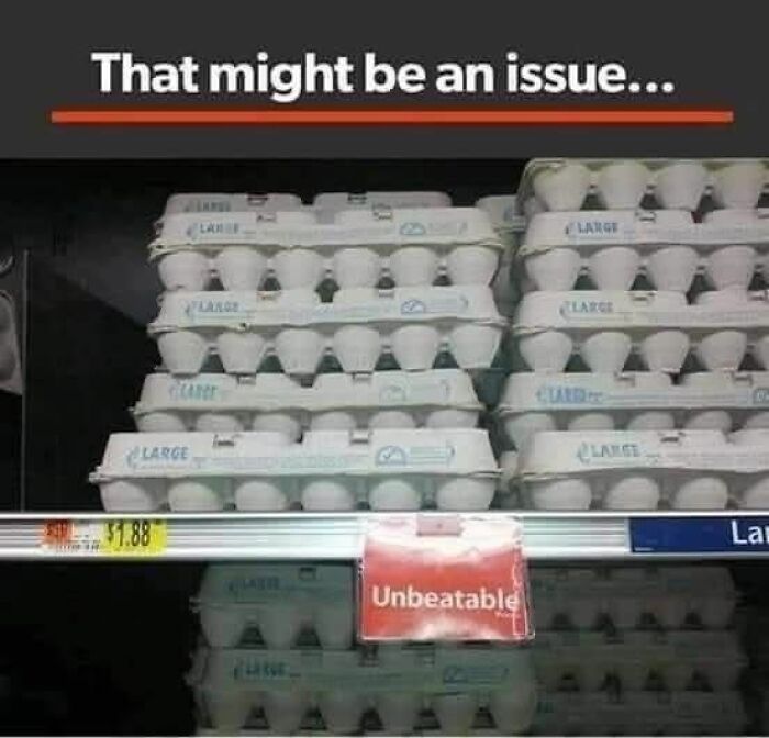 Egg cartons stacked unevenly on a grocery shelf with a sign labeled unbeatable, illustrating a hilarious food meme moment.