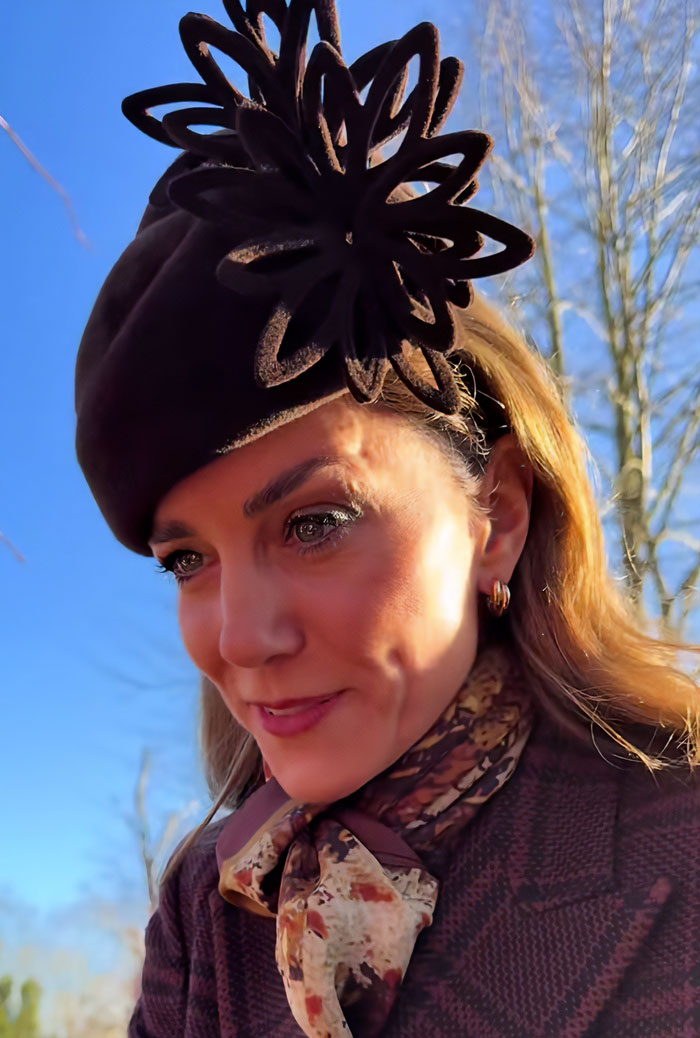 Kate Middleton wearing a brown hat and scarf during Christmas appearance, sparking scar and cancer conspiracy theories. Kate Middleton wearing a brown hat and scarf during Christmas appearance, sparking scar and cancer conspiracy theories.
