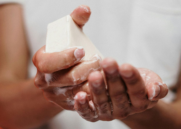 A person washing hands with soap showing daily hygiene, highlighting surprising facts and misconceptions about prison life.