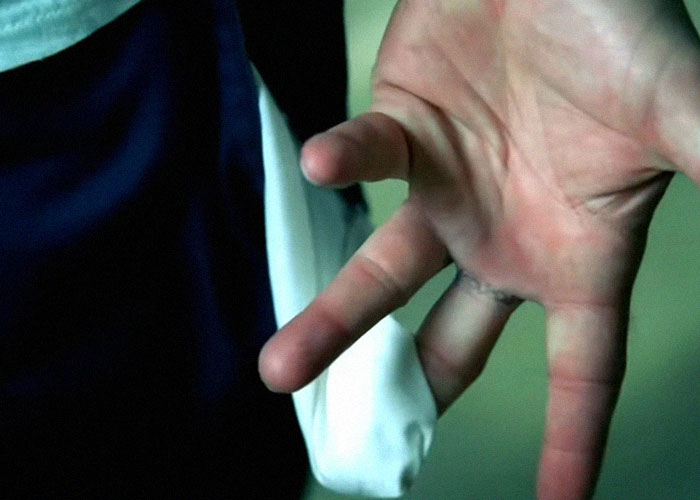 Close-up of a hand gesture symbolizing surprising facts and misconceptions about prison life explained by inmates.