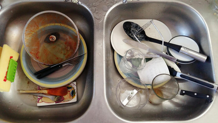 Dishwasher filled with dirty dishes and utensils, symbolizing challenges faced by folks who quit their jobs fast.