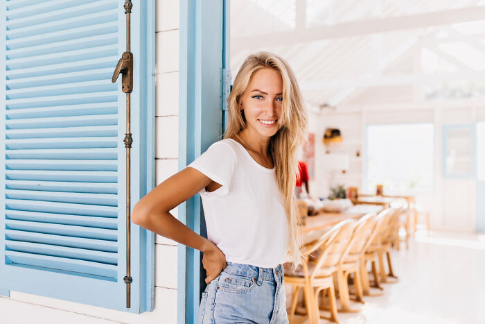 Young woman smiling casually indoors, representing stories from folks who quit their jobs in record time.
