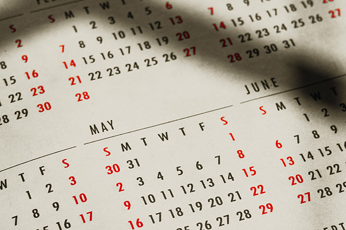 Calendar pages showing dates in May and June with visible shadows highlighting random facts concept.