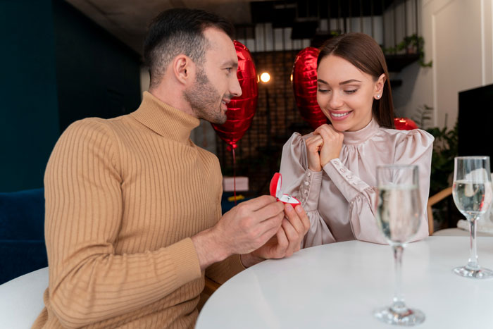 Man presenting an engagement ring to a woman at a table, capturing a moment of refuse buying engagement ring choice. Man presenting an engagement ring to a woman at a table, capturing a moment of refuse buying engagement ring choice.