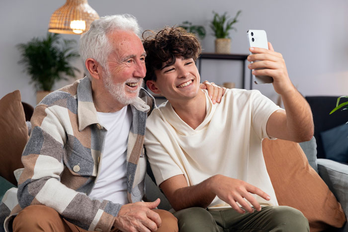 Grandfather and teenage grandson taking a selfie together, highlighting connection despite refusing establish relationship fathers kids. Grandfather and teenage grandson taking a selfie together, highlighting connection despite refusing establish relationship fathers kids.