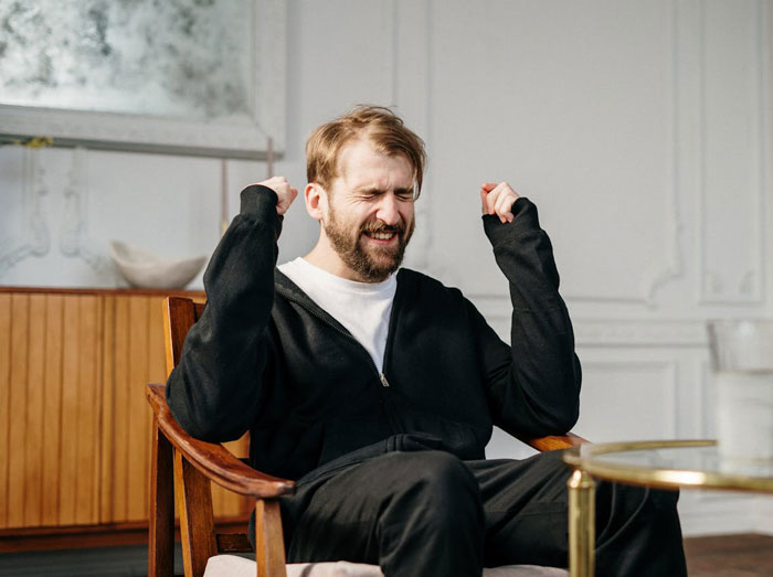 Man in black jacket sitting in chair with clenched fists and eyes closed showing frustration over picky eater demands. Man in black jacket sitting in chair with clenched fists and eyes closed showing frustration over picky eater demands.